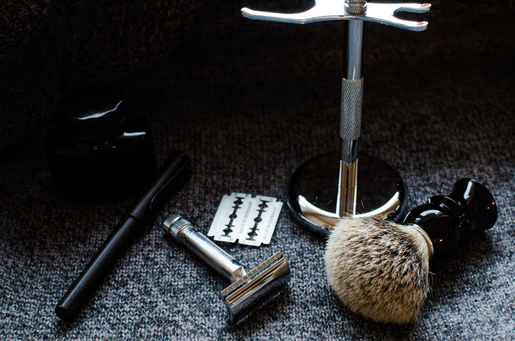 An image of a safety razor, brush, and stand