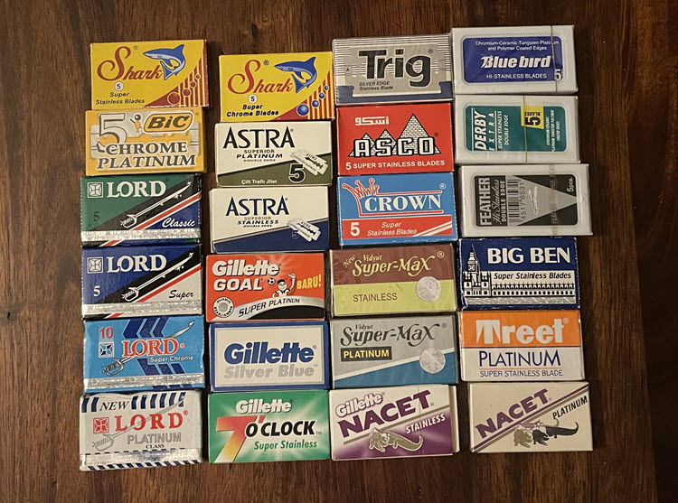 An image showing packs of safety/DE razor blades from a variety of manufacturers to include Lord, Bic, Shark, Astra, Gillette, Trig, ASCO, Crown, Vidyut, Bluebird, Derby, Feather, Big Ben, and Treet.