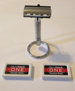 MicroTouch One razor hanging on stand with razor blade boxes in front