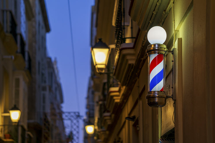 Barbershop Light Sign at Night with Blurred Street Lights Cadiz Andalusia Spain
