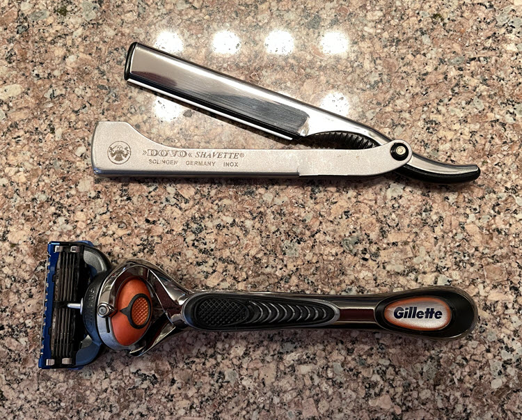 A Dovo shavette above a Gillette Fusion Proglide razor with Flexball handle.